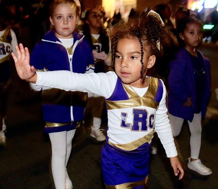 The Recreation Department Cheerleaders wave to the crowd on D Street.